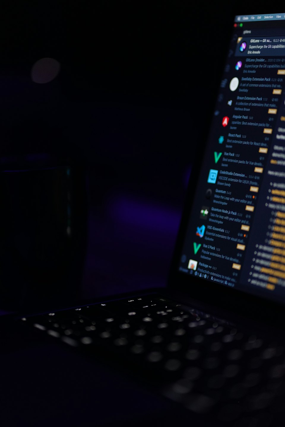 Open laptop screen displaying lines of computer code and software.